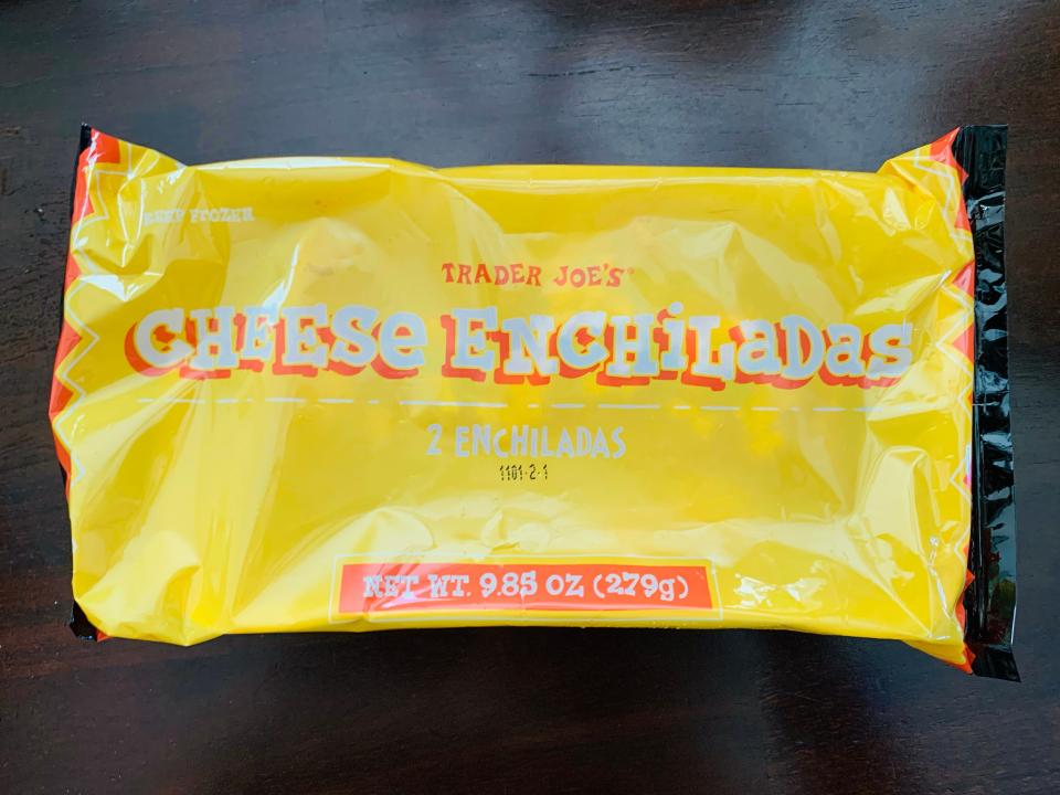 bright Yellow package of Trader Joe's cheese enchiladas on a wooden table