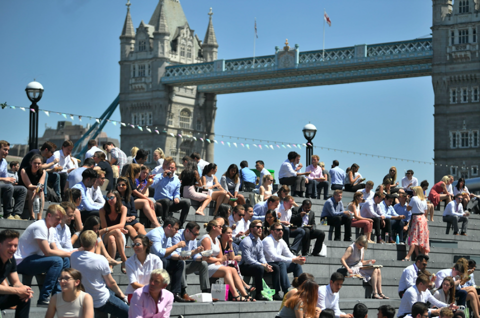<em>Workers stop for a spot of lunch in the sunshine next to Tower Bridge in London (PA)</em>