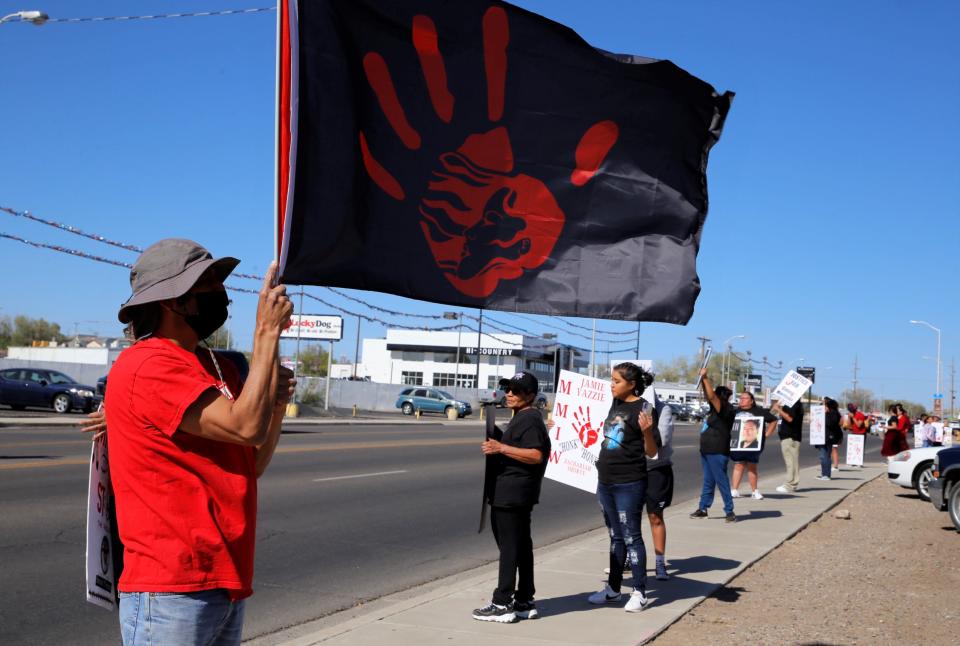 Participants at the missing and murdered Indigenous women and people awareness day rally on May 5 stand along San Juan Boulevard in Farmington.