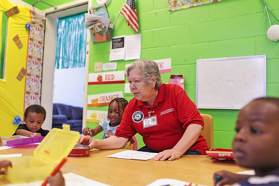 An AmericaCorps Senior Foster Grandparent works with students in this undated photo. Central Missouri Community Action coordinates the program locally and is need of more volunteers.