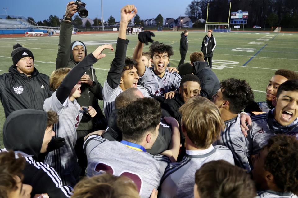 Caravel players celebrate after shutting out Saint Mark's 4-0 for their second straight DIAA Division II Boys Soccer championship on Saturday at Dover High.