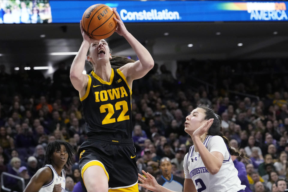 Iowa guard Caitlin Clark (22) drives to the basket past Northwestern guard Caroline Lau during the first half of an NCAA college basketball game in Evanston, Ill., Wednesday, Jan. 31, 2024. (AP Photo/Nam Y. Huh)