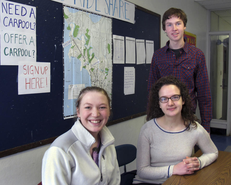 Burlington High School seniors Abby Massell, left, Sabine Rogers and Henry Prine pose in front of a map they helped create to assist students to find rides to and from school as a strike by local bus drivers continued into its second week Wednesday, March 26, 2014, in Burlington, Vt. (AP Photo/Wilson Ring)