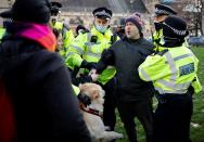 Police officers detain a protestor during an anti-COVID-19 lockdown demonstration outside the Houses of Parliament in Westminster, central London on January 6, 2021. - Britain toughened its coronavirus restrictions on Tuesday, with England and Scotland going into lockdown and shutting schools, as surging cases have added to fears of a new virus variant. (Photo by Tolga Akmen / AFP) (Photo by TOLGA AKMEN/AFP via Getty Images)