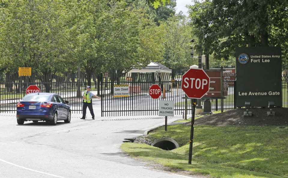 This Monday, Aug. 25, 2014 file photo shows security guards opening a gate for motorist at the visitor entrance to Fort Lee, Va., Monday, Aug. 25, 2014. As much as President Donald Trump enjoys talking about winning and winners, the Confederate generals he vows will not have their names removed from U.S. military bases were not only on the losing side of rebellion against the United States, some weren't even considered good generals. Or even good men. The 10 generals include some who made costly battlefield blunders; others mistreated captured Union soldiers, some were slaveholders, and one was linked to the Ku Klux Klan after the war. (AP Photo/Steve Helber, File)