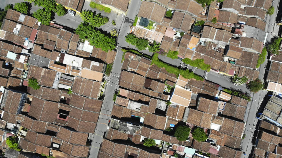 An aerial photo shows quiet streets during social distancing in Hoi An, Vietnam, Friday, July 31, 2020. The old town, Vietnam's top tourist attraction, starts two weeks of social distancing on Friday morning in an attempt to contain the spread of the coronavirus. (AP Photo/Hieu Dinh)