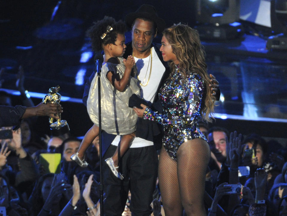 FILE - This Aug 24, 2014 file photo shows Beyonce on stage with Jay Z and their daughter Blue Ivy as she accepts the Video Vanguard Award at the MTV Video Music Awards in Inglewood, Calif. Beyonce announced on her Instagram account, Wednesday, Feb. 1, 2017, that she is expecting twins. (Photo by Chris Pizzello/Invision/AP, File)