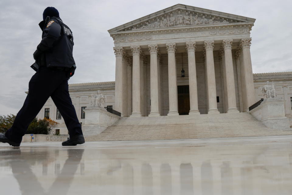 A U.S. Supreme Court police officer walks past its building as rulings are expected in Washington, U.S. November 22, 2021. REUTERS/Jonathan Ernst