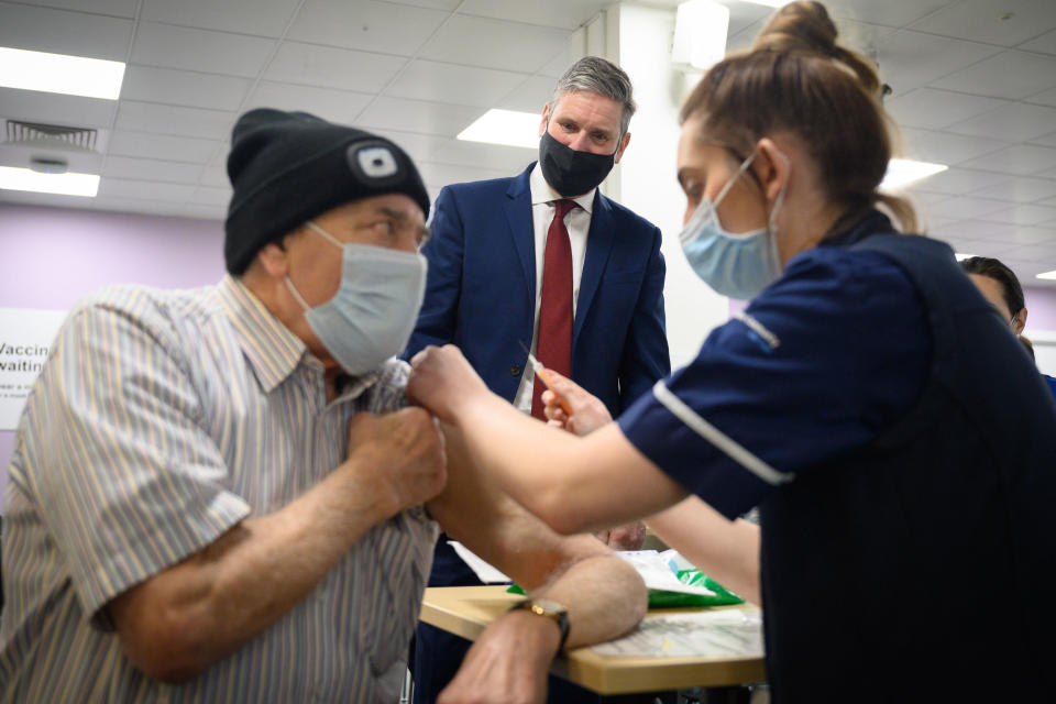 <p>Labour leader Sir Keir Starmer looks on as Melvin Allanson receives the first of two Covid-19 vaccination shots, during a visit to the vaccination centre at Robertson House, in Stevenage.</p> (AFP/Getty)