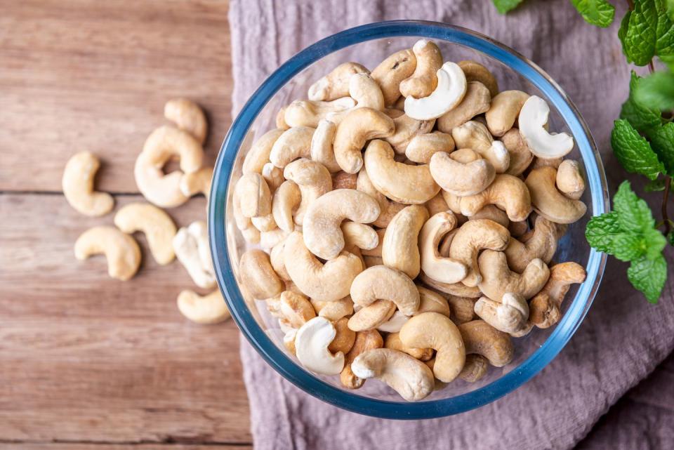 cashew nuts on wooden background, top view