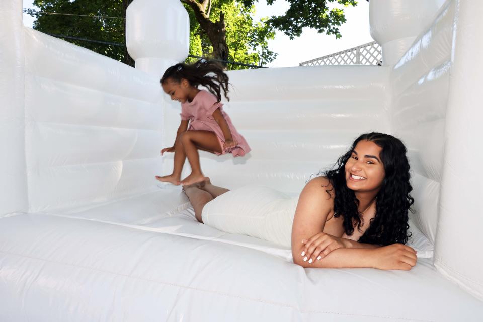 Jalani Jumps owner Nayara Barbosa of Brockton tries out one of her bounce houses with her daughter Jalani on Saturday, June 25, 2022.