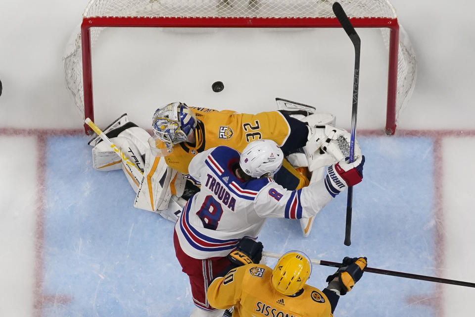 New York Rangers defenseman Jacob Trouba (8) celebrates a goal against Nashville Predators goaltender Kevin Lankinen (32) during the second period of an NHL hockey game Saturday, Dec. 2, 2023, in Nashville, Tenn. The Rangers won 4-3. (AP Photo/George Walker IV)