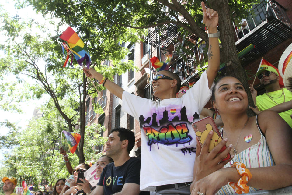 Elaine McWilliams, foreground second from right, and her wife, Christina McWillams, foreground right, react as they watch the LGBTQ Pride march, Sunday, June 30, 2019, in New York. The couple are from Brentwood, New York. (AP Photo/Tina Fineberg)