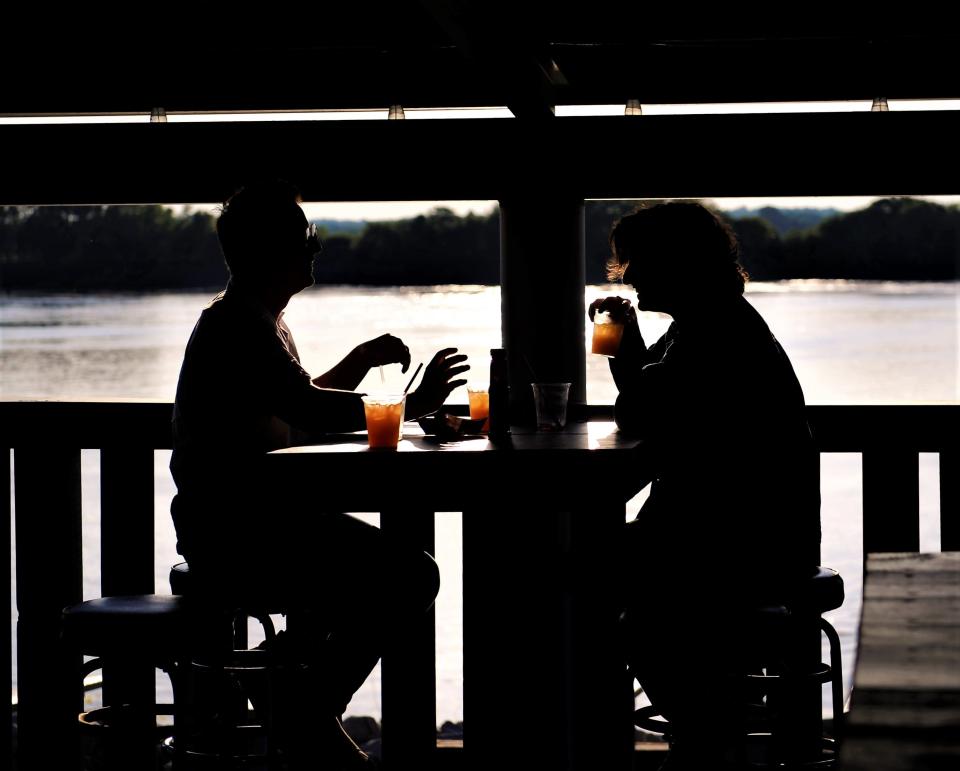 Guests enjoy drinks on the riverside deck at the Marina Pointe Restaurant, Bar and Nightclub on Saturday, May 28, 2022.