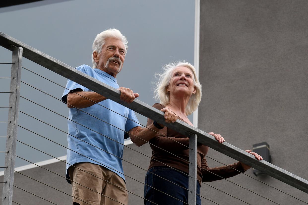 Larry Koch and Pam Davison look our over the valley below their home near Yerba Buena Road on Wednesday, Oct. 25, 2023. The couple lost their home in the Woolsey Fire, before eventually rebuilding with materials more resistant to fire.