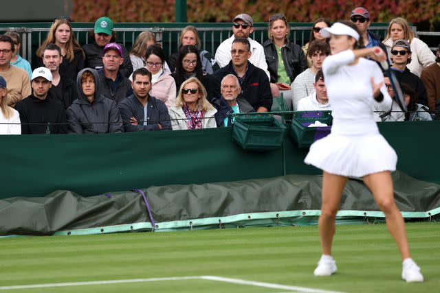 <p>Julian Finney/Getty</p> Jannik Sinner of Italy watches Anna Kalinskaya as she plays in her Ladies' Singles first round match against Panna Udvardy of Hungary during day two of The Championships Wimbledon 2024 at All England Lawn Tennis and Croquet Club on July 02, 2024