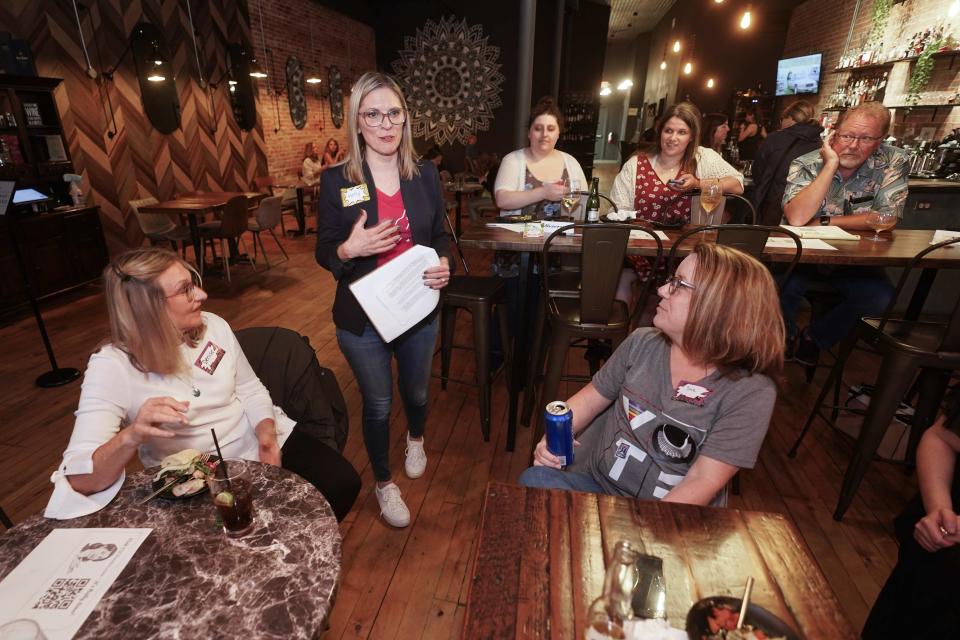 Kelly Dillaha, second from left, talks during a Red Wine and Blue event in Utica, Mich., Tuesday, Sept. 20, 2022. (AP Photo/Paul Sancya)