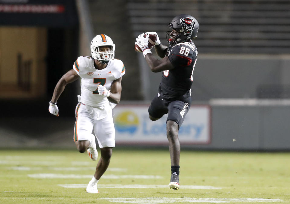 North Carolina State wide receiver Emeka Emezie (86) pulls in a reception in front of Miami cornerback Al Blades Jr. (7) during the first half of an NCAA college football game Friday, Nov. 6, 2020, in Raleigh, N.C. (Ethan Hyman/The News & Observer via AP, Pool)