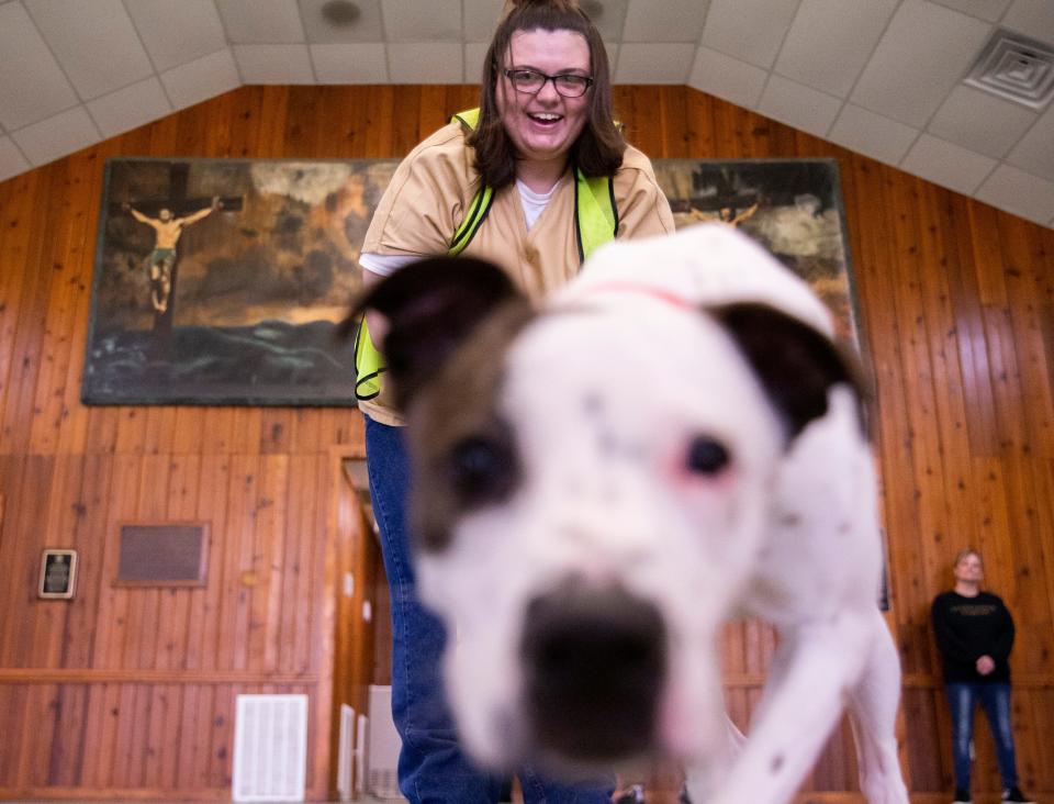 Destiny Worley, an inmate within the Shelby County Division of Corrections, smiles as she holds the leash for Crab Rangoon, “Crabbie” for short, a dog she trained within the prison, during a group training session at the prison in Memphis, Tenn., on Tuesday, April 2, 2024. Worley was part of the PAWsitive Dog Training Program, which allowed six female inmates that are soon to be released to train dogs that are looking for homes with skills that will make them more adoptable.