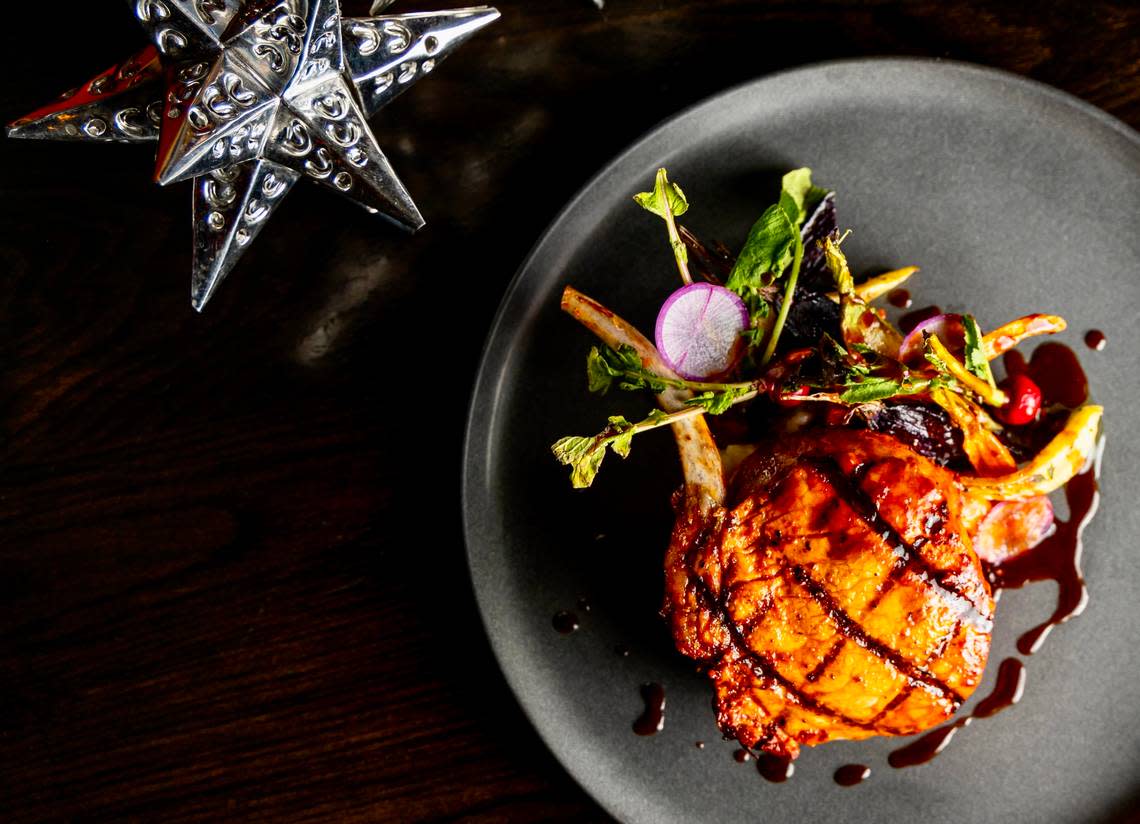 A pork chop with chili-adobo marinade is the feature on Toro Toro’s holiday menu.