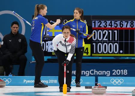 Curling - Pyeongchang 2018 Winter Olympics - Women's Final - Sweden v South Korea - Gangneung Curling Center - Gangneung, South Korea - February 25, 2018 - Sara McManus of Sweden and her teammate Anna Hasselborg react behind Kim Seon-yeong of South Korea. REUTERS/Phil Noble