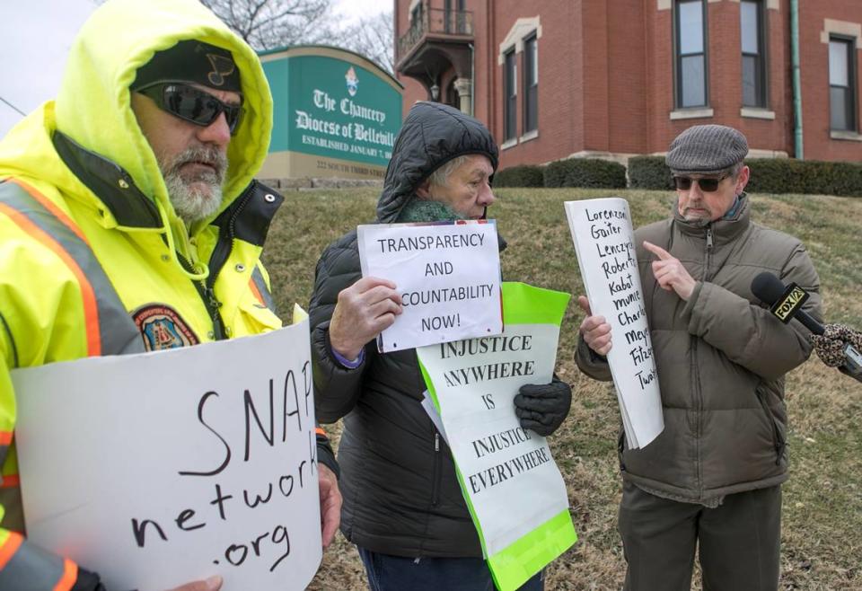 David Clohessy, right, speaks to reporters while protesting with John Duffin and Anne Harter outside the Catholic Diocese of Belleville chancery in 2019. All are activists with the Survivors Network of those Abused by Priests.