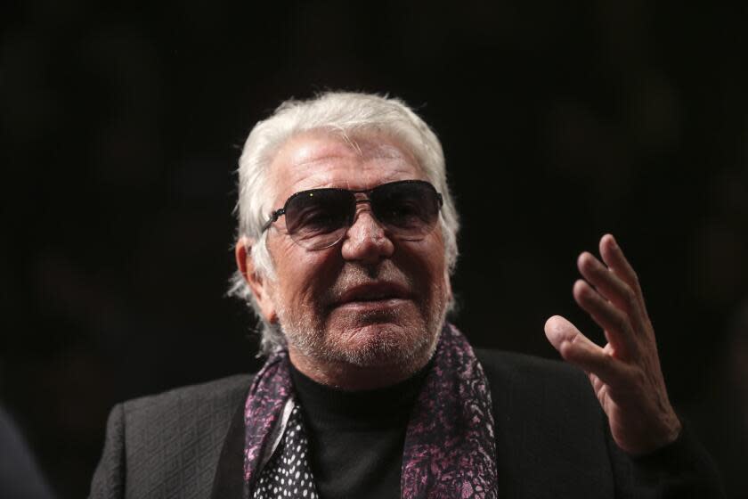 Italian fashion designer Roberto Cavalli talks with journalists prior to the start of the Roberto Cavalli men's Fall-Winter 2014 show, part of the Milan Fashion Week, unveiled in Milan, Italy, Tuesday, Jan.14, 2014. Italy's world-famous fashion designer Roberto Cavalli – known for his flamboyant and glamorous style -- died on Friday, April 12, 2024 aged 83, his company announced in an Instagram post. (AP Photo/Luca Bruno)