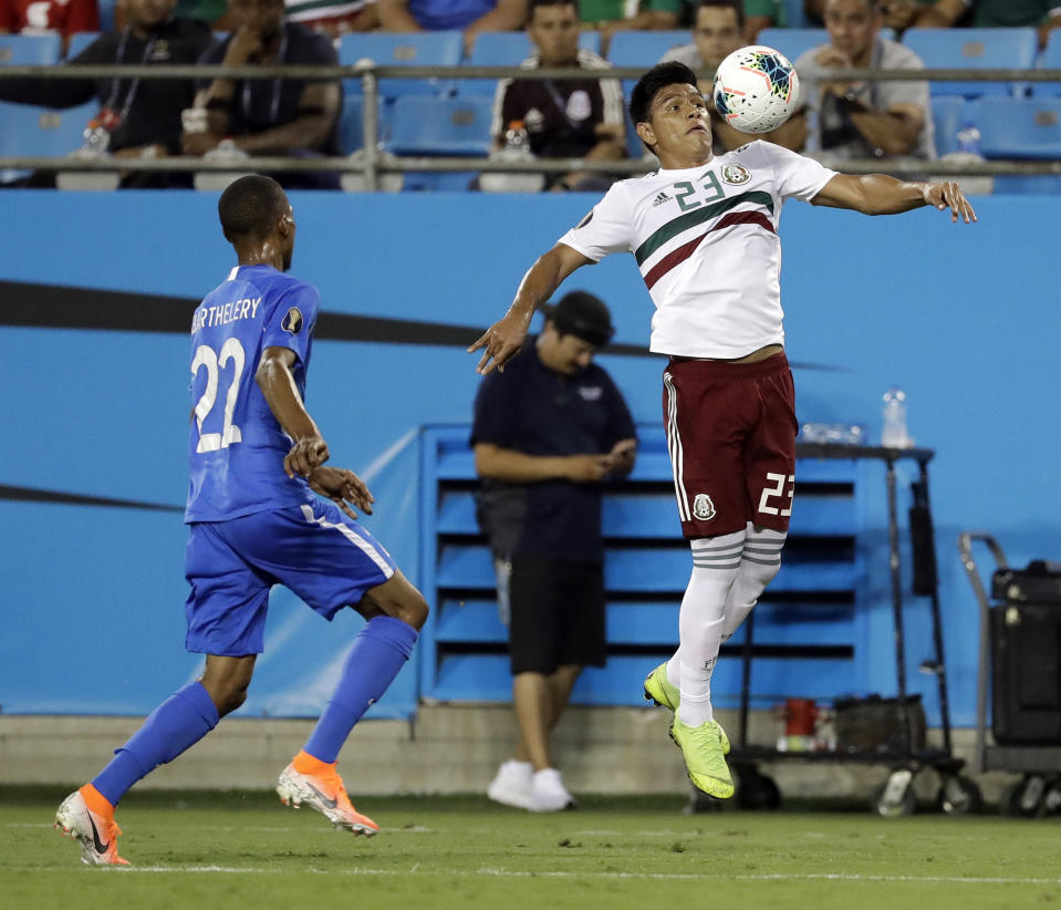 Mexico's Jesus Gallardo (23) moves the ball against Martinique's Romario Barthelery (22) during the first half of their CONCACAF Golf Cup soccer match in Charlotte, N.C., Sunday, June 23, 2019. (AP Photo/Chuck Burton)