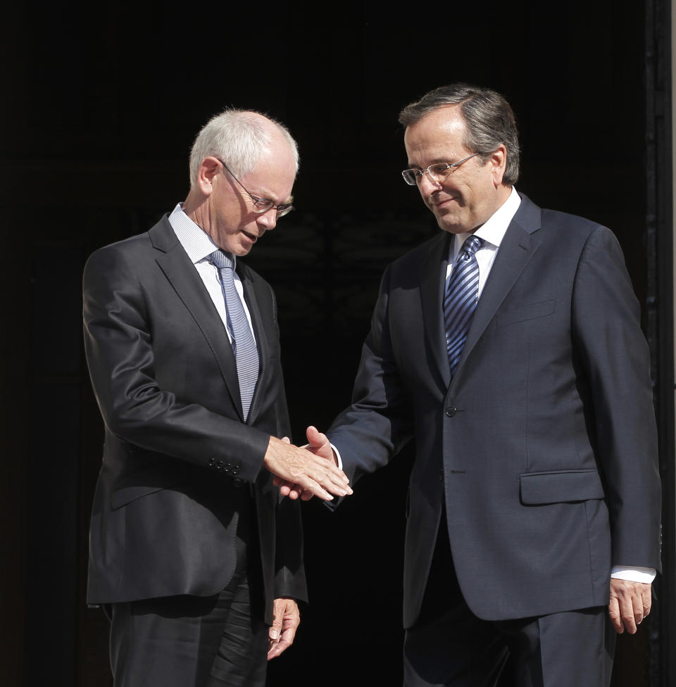 Greek prime minister Antonis Samaras, right, welcomes European Council president Herman Van Rompuy prior to their meeting in Athens, Friday, Sept. 7, 2012. Greece is struggling to meet budget commitments needed for continued emergency financing from eurozone countries and the International Monetary Fund. (AP Photo/Petros Giannakouris)