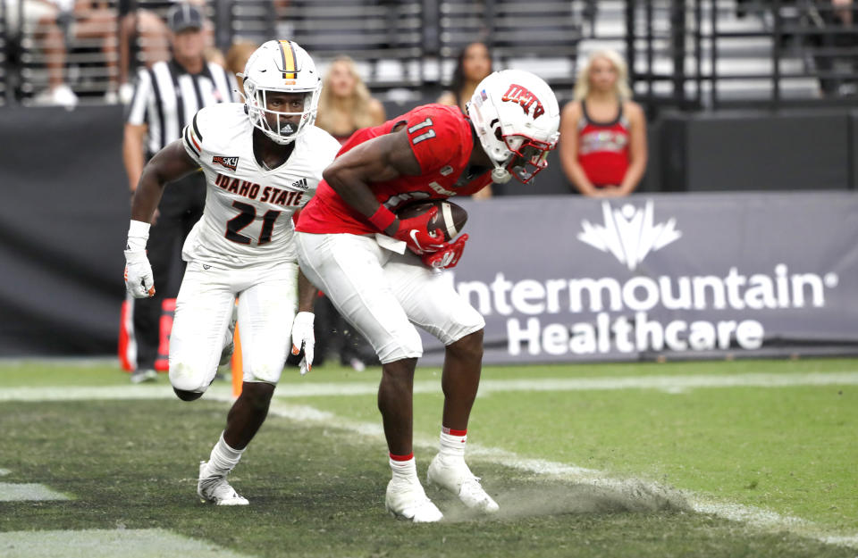 UNLV wide receiver Ricky White (11) catches a pass in the end zone ahead of Idaho State cornerback Jihad Brown (21) during the first half of an NCAA college football game at Allegiant Stadium, Saturday, Aug. 27, 2022, in Las Vegas. (Steve Marcus/Las Vegas Sun via AP)