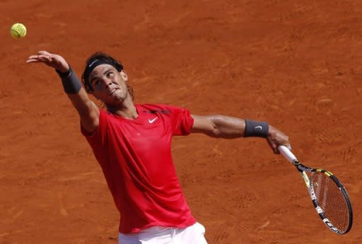 Spain's Rafael Nadal serves to Italy's Simone Bolelli at the Roland Garros stadium in Paris. Nadal overcame a second-set blip as he thrashed Bolelli 6-2, 6-2, 6-1