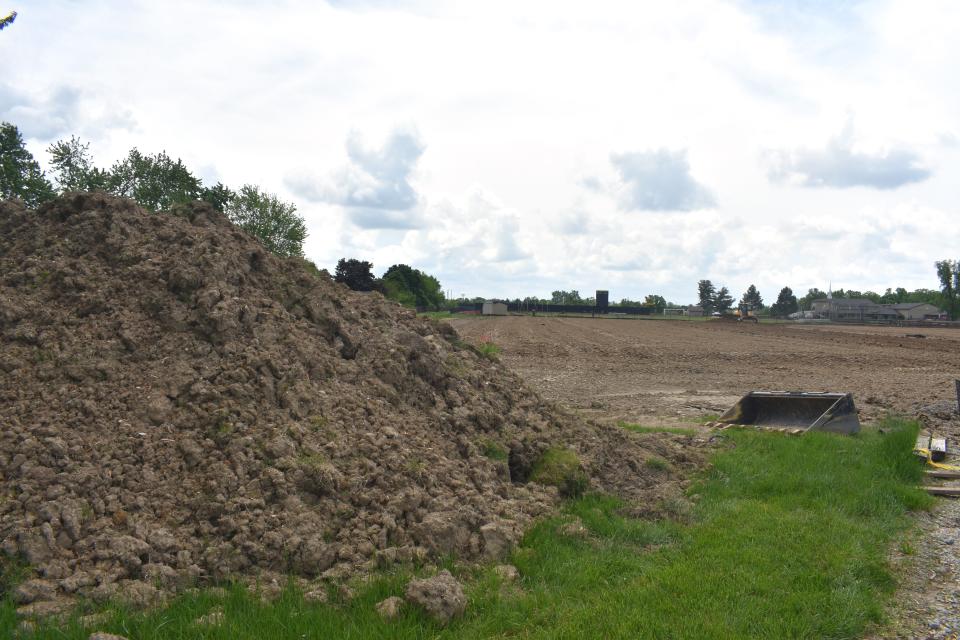 A mound of dirt is pictured Friday where crews have been preparing the site for Adrian College's new inflatable sports dome. The dome, which is expected to be used by several athletic programs including football, soccer, lacrosse, rugby, and track and field, has become an issue for nearby residents. The apex of the dome is expected to be 90 feet high.