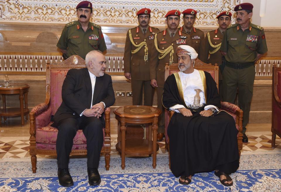 In this Sunday, Jan. 12, 2020 photo, made available by the Oman News Agency, Oman's new Sultan Haitham bin Tariq Al Said, right, receives Iranian Foreign Minister Javad Zarif, after his arrival to attend an official mourning ceremony for the late Sultan Qaboos, in Muscat, Oman. A flurry of diplomatic visits and meetings crisscrossing the Persian Gulf are driving urgent efforts to defuse the possibility of all-out war after the U.S. killed Iran's top military commander. Global leaders and top diplomats are repeating in recent days the mantra of “de-escalation” and “dialogue,” yet none have publicly laid out a path to achieving either. (Oman News Agency via AP)