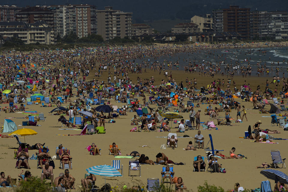 People on the beach during a summer's day, in Laredo, northern Spain, Saturday, July 17, 2021. (AP Photo/Alvaro Barrientos)
