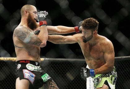 Andrei Arlovski (R) and Travis Browne trade blows at UFC 187. (AP)