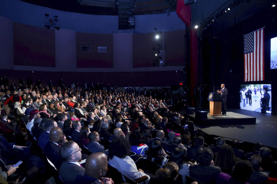 A wide shot of the audience in the theater with Mayor Eric Adams at the podium.