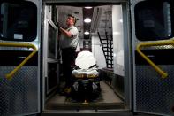 REACT EMS paramedic Andrew Sherman disinfects an ambulance in Shawnee