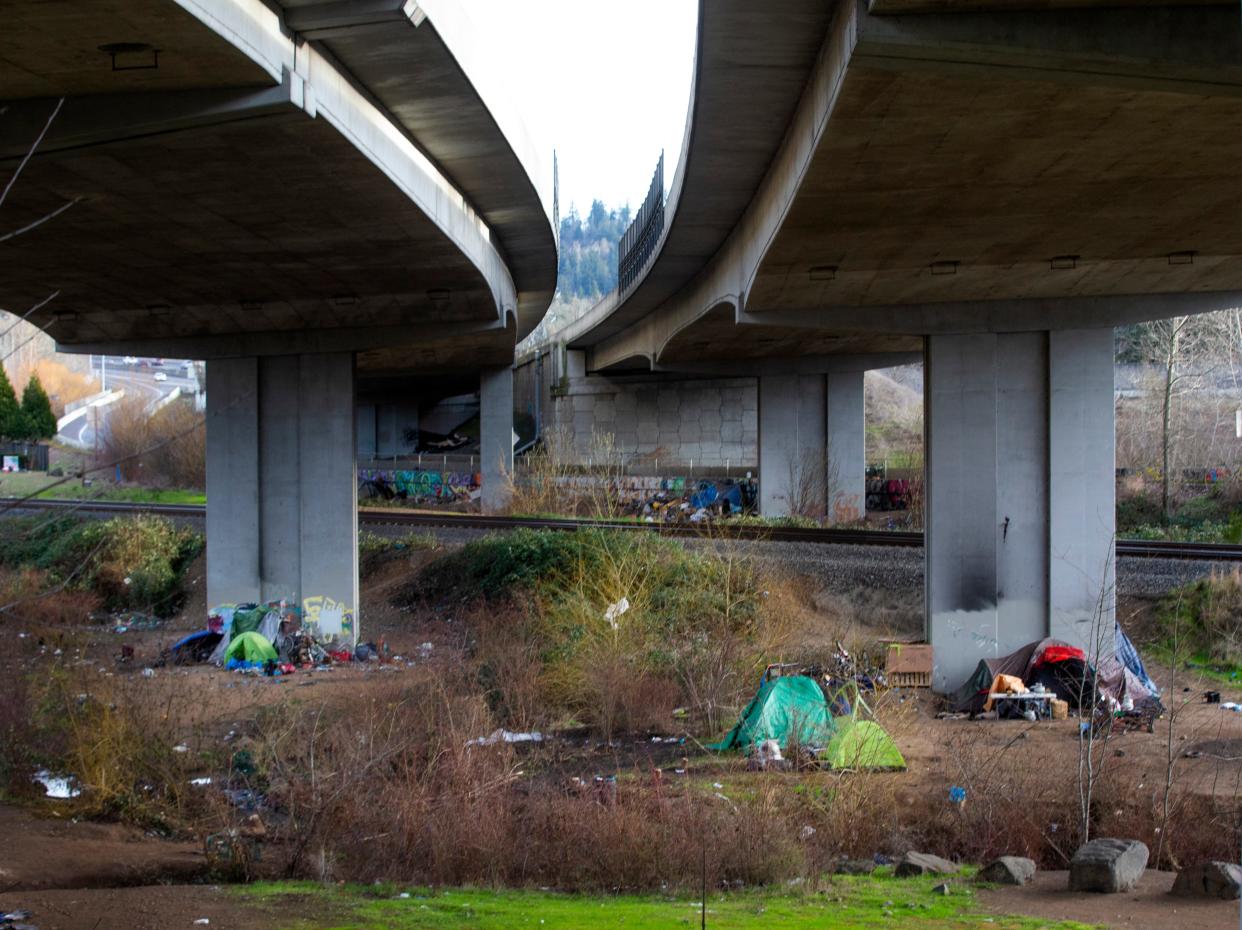 Tents occupy an area under the Whilamut Passage Bridge near the railroad tracks between Glenwood and Eugene.