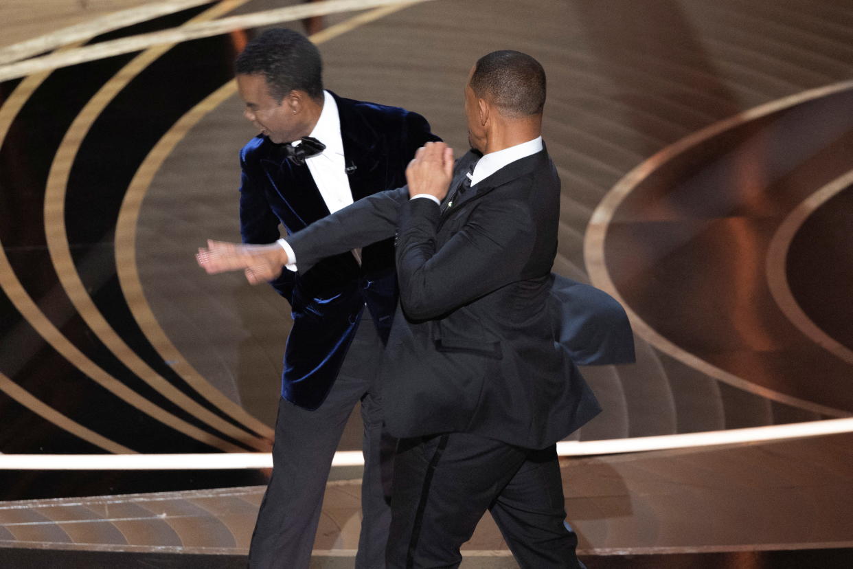 Will Smith (R) hits Chris Rock as Rock spoke on stage during the 94th Academy Awards in Hollywood, Los Angeles, California, U.S., March 27, 2022. Picture taken March 27, 2022. REUTERS/Brian Snyder BEST AVAILABLE QUALITY