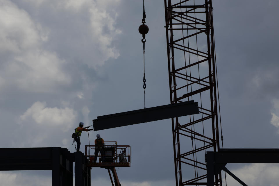 FILE - Iron workers construct the framework of a $4 billion Panasonic EV battery plant Thursday, May 18, 2023, near DeSoto, Kan. As he embarks on his reelection campaign, just 33% of American adults say they approve of President Joe Biden's handling of the economy and only 24% say national economic conditions are in good shape, according to a new poll from The Associated Press-NORC Center for Public Affairs Research. (AP Photo/Charlie Riedel, File)