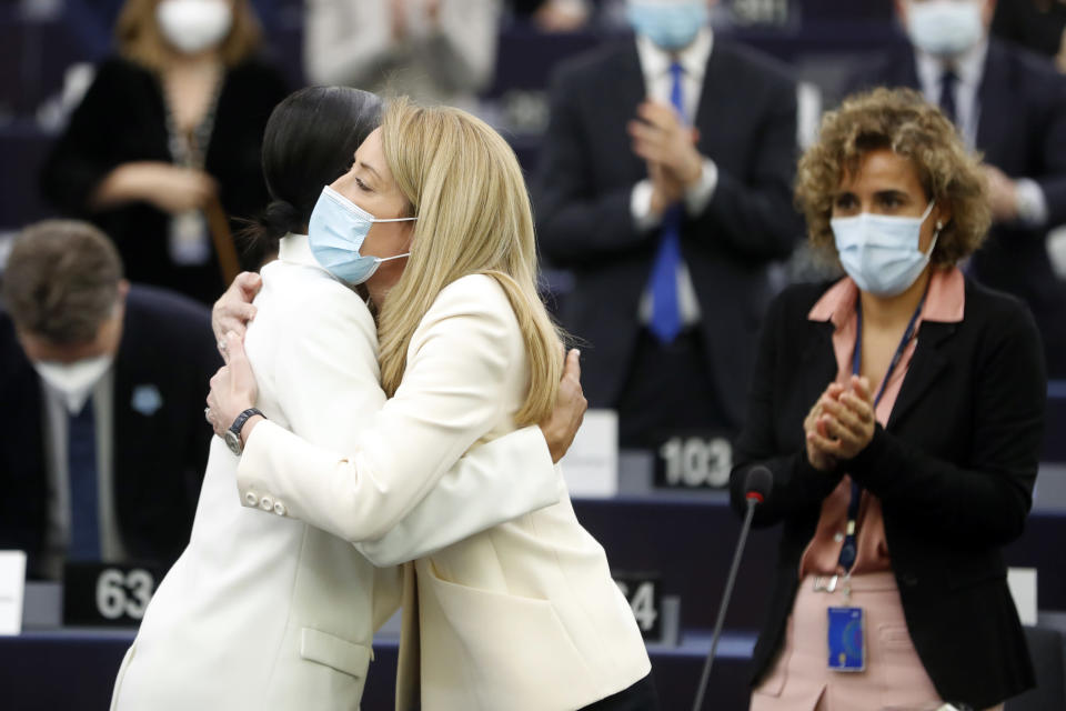 Christian Democrat Roberta Metsola of Malta hugs Swedish Alice Khunke, at the European Parliament, in Strasbourg, eastern France, Tuesday, Jan 18, 2022. Metsola was elected president of the European Union's parliament Tuesday, taking over for a 2 ½-year term following the death of Socialist David Sassoli last week. (AP Photo/Jean-Francois Badias)