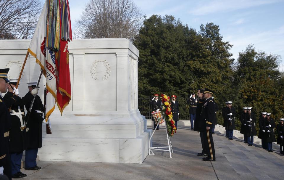 Spanish Prime Minister Mariano Rajoy, center, is accompanied by Army Maj. Gen. Jeffrey S. Buchanan, center right, as he lays a wreath at the Tomb of the Unknowns at Arlington National Cemetery, Monday, Jan. 13, 2014. Rajoy is in Washington to meet with President Barack Obama to discuss their support for the Transatlantic Trade and Investment Partnership, a proposed U.S.-European Union trade agreement currently in the midst of negotiations, and discuss promoting economic growth and jobs, cooperation within the North Atlantic Treaty Organization, their common interests in Latin America and challenges in North Africa and the Middle East. (AP Photo/Charles Dharapak)