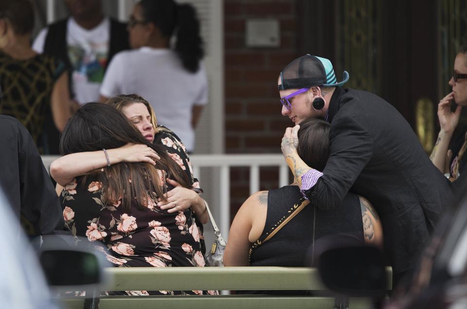 <p>Mourners embrace before the funeral service for Kimberly Morris, one of the victims of the Pulse nightclub mass shooting, in Kissimmee, Fla. <em>(Photo: David Goldman/AP)</em> </p>