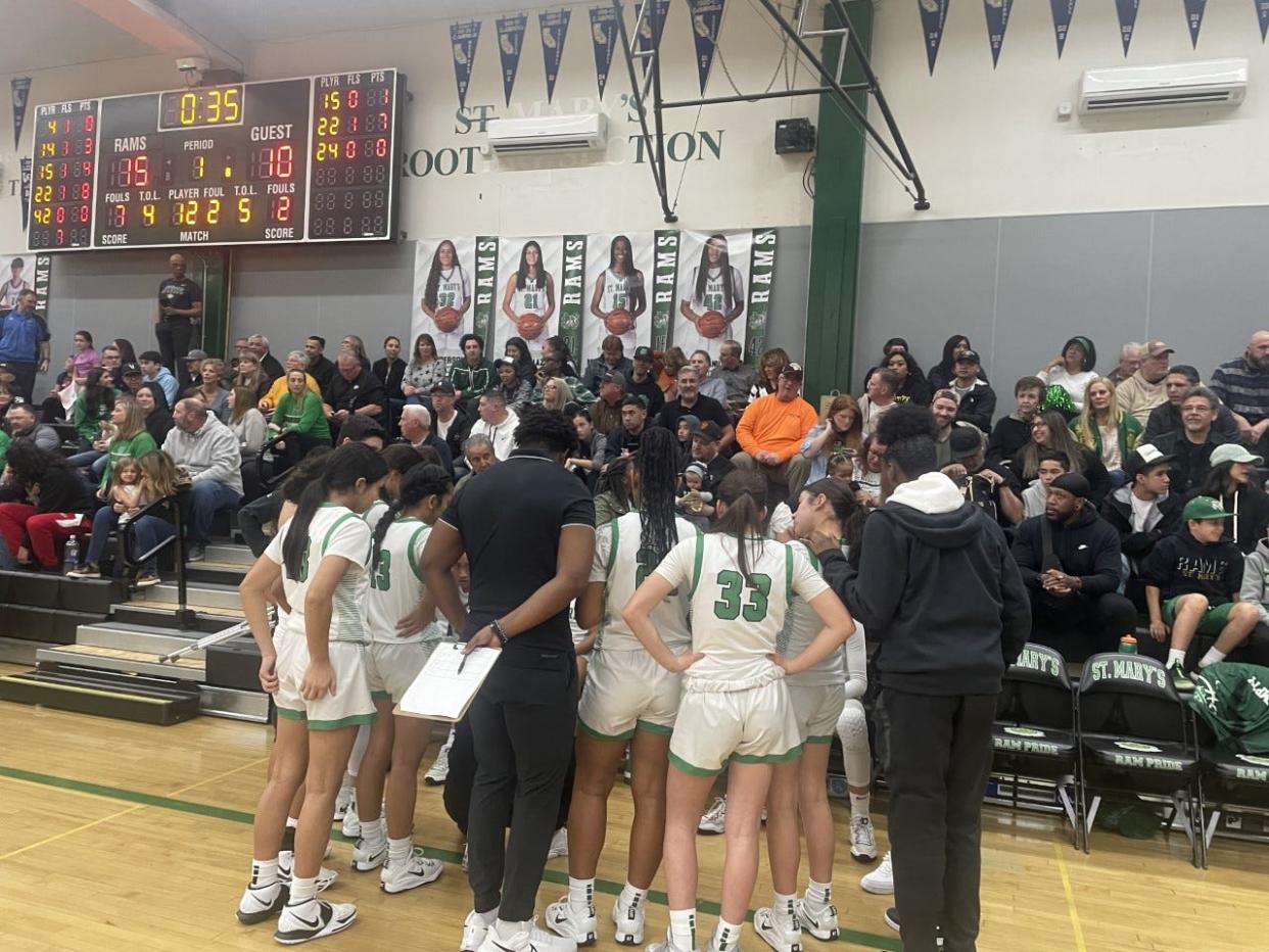 St. Mary's girls basketball huddle together during one of its timeouts in Saturday's game against Clovis at St. Mary's High school.