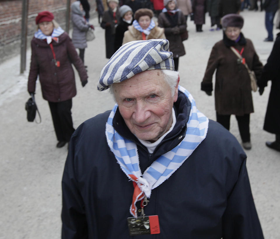 A Holocaust survivor walks inside the former concentration camp before a ceremony to mark the 69th anniversary of the liberation of Auschwitz Nazi death camp's in Oswiecim, Poland, on Monday, Jan. 27, 2014, since the Soviet Red Army liberated the camp. Israeli lawmakers and government officials are to attend anniversary observances later in the day. The Nazis killed some 1.5 million people, mostly Jews at the camp during World War II. (AP Photo/Czarek Sokolowski)