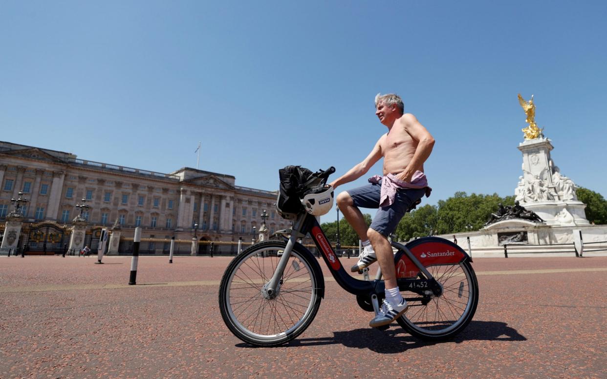 A man cycles past Buckingham Palace - John Sibley/Reuters