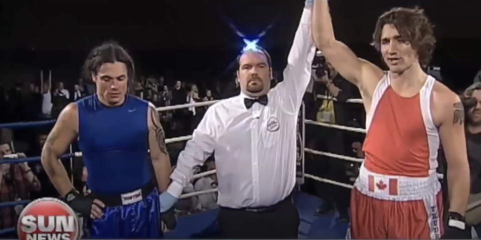 The ref holding up Trudeau's arm, indicating him as the winner