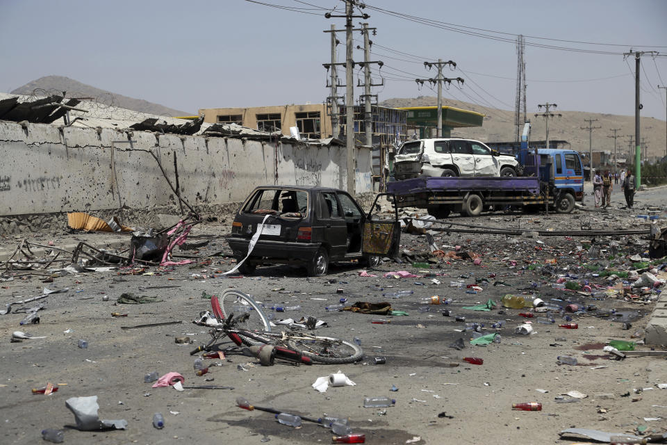 Damaged cars are seen at the site of a suicide attack in Kabul, Afghanistan, Thursday, July 25, 2019. Three bombings struck the Afghan capital on Thursday, killing at least eight people, including five women and one child, officials said Thursday. (AP Photo/Rahmat Gul)