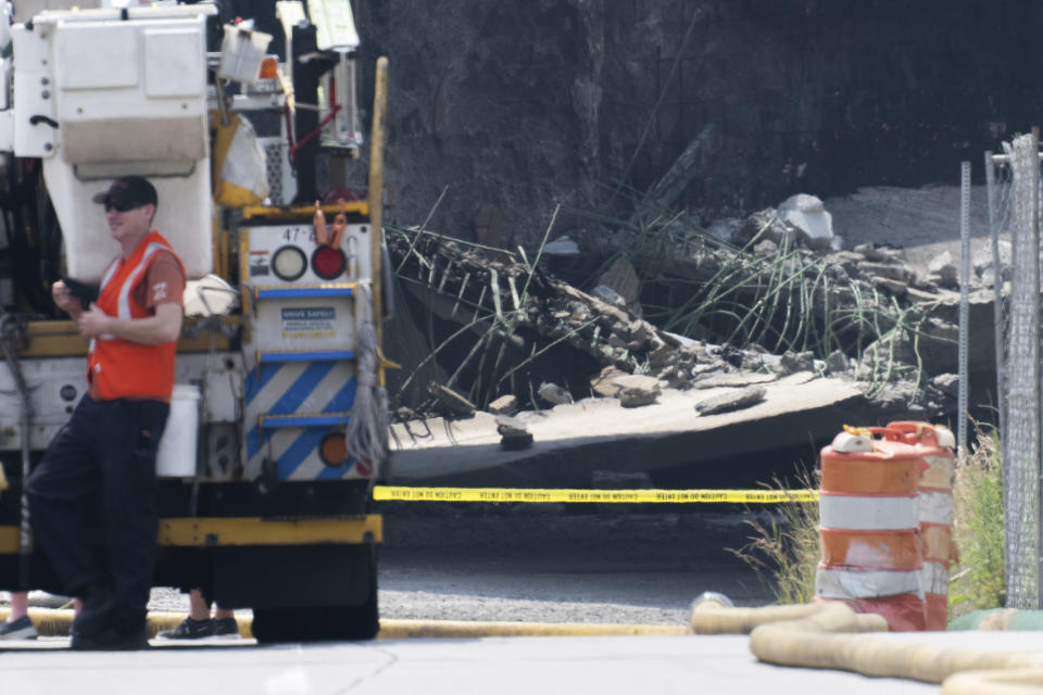 Officials work on the scene following a collapse on I-95 after a truck fire, Sunday, June 11, 2023 in Philadelphia. (AP Photo/Joe Lamberti)