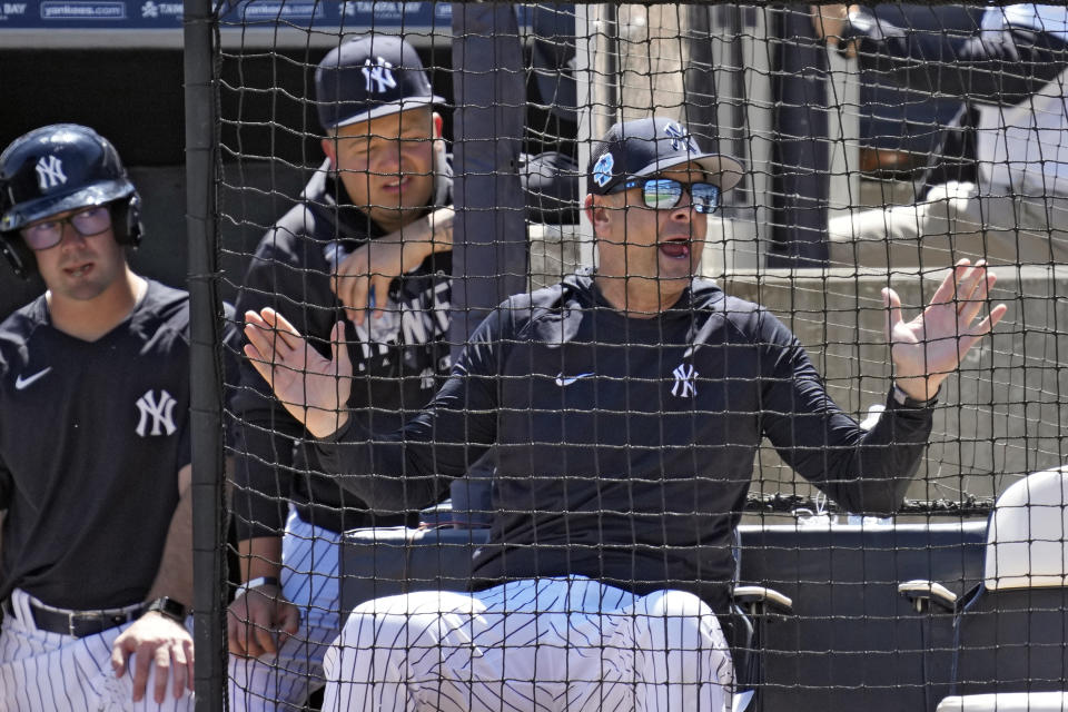 New York Yankees manager Aaron Boone gestures a home plate umpire Jerry Layne after Detroit Tigers' Austin Meadows was awarded a walk on a clock violation by pitcher Luis Severino during the fourth inning of a spring training baseball game Tuesday, March 21, 2023, in Tampa, Fla. (AP Photo/Chris O'Meara)